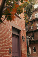 Lantern near entrance of brick building in New York City.