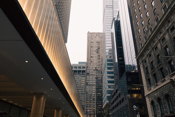 Fototapeta na wymiar illuminated entrance of building on urban street in midtown of New York City.