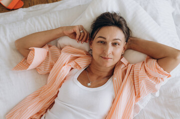 Mature female lying on bed