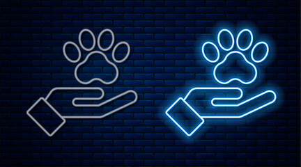 Glowing neon line Hands with animals footprint icon isolated on brick wall background. Pet paw in heart. Love to the animals. Vector