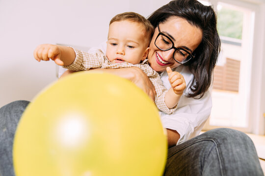 Woman playing with a baby boy 