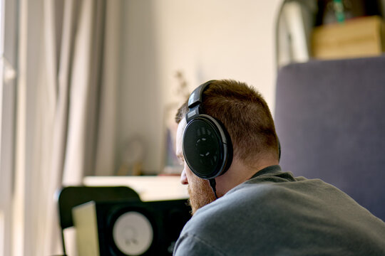 Young man from behind wearing headphones