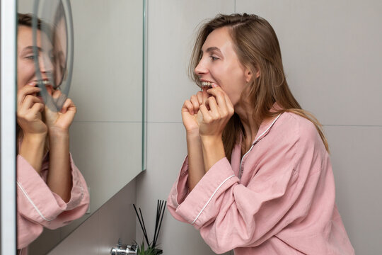 Woman puts orthodontics retainer on