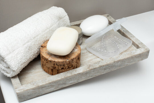 Soap, creme, towel and case with transparent aligner on table