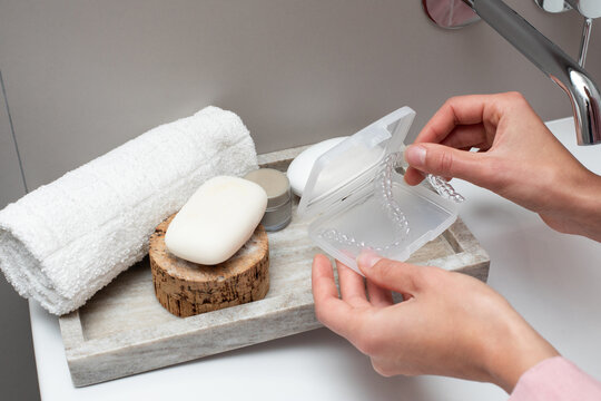 Still life of bathroom towel, soap and case for aligner