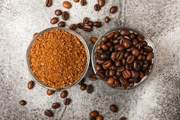 Coffee granules and coffee beans on a black textured background. Instant coffee drink. Energy hot drink. Place for text. Place for copy. Cheerful morning concept.