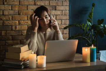 Young woman using laptop to work at home during electricity outage. Remote work at home concept....