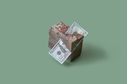 Dollar stuck in grunge natural stone block.