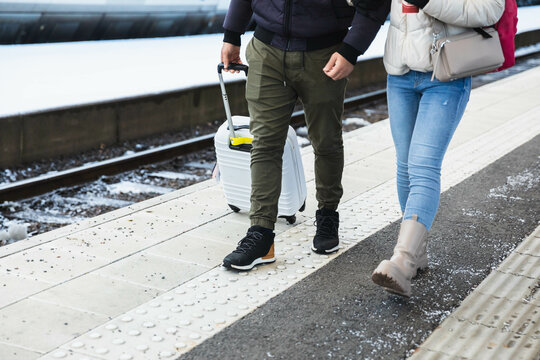 Unrecognizable People Walking With Suitcase