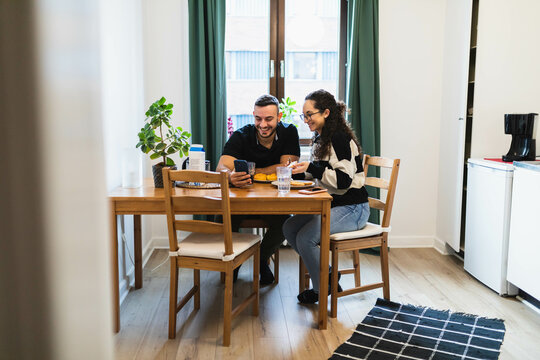 Happy couple eating in a kitchen room
