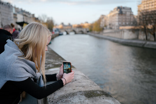 Teenager taking a photo in Paris. 