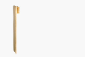Bamboo toothbrush on a white isolated background. Eco-friendly wooden toothbrush without plastic. Waste-free personal care products, dental care concept. Free space for text