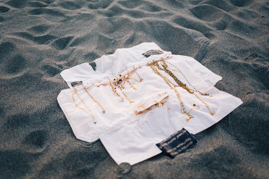 Jewelry displayed on a sandy beach
