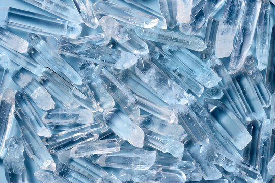 Transparent quartz crystals on blue background.
