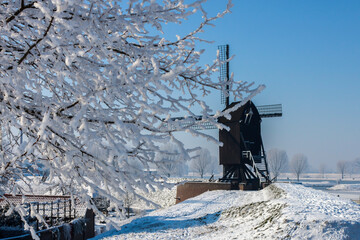 Old windmill on a winter background on a sunny day