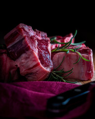 Thick-cut lamb chops with fresh rosemary ready for the grill or broiler.