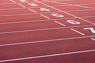 Fototapeta premium Red running racetrack finishing line with numbers 2-7. Landscape or horizontal photo.