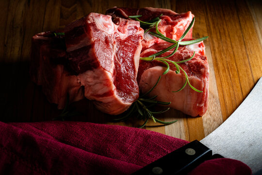 Thick-cut lamb chops with fresh rosemary ready for the grill or broiler.