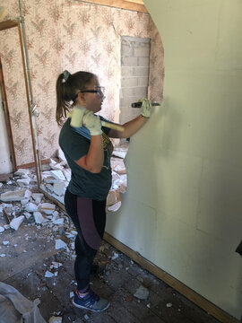 UGC young woman demolishing wall