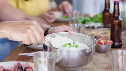 Happy family eating in a traditional brazilian barbecue. Eating white rice. 