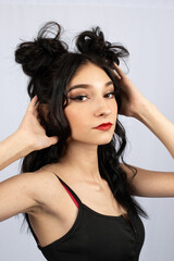 model with black hair with half up down space buns hairstyle style rave event fun fashion beauty caucasian light complexion alternative modeling nose ring red lipstick bun creative