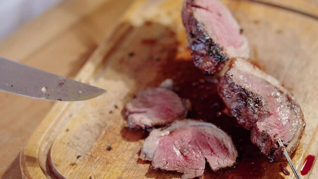 Close up of Picanha on skewer in a Traditional Churrasco Brazilian Barbecue. Being Cut
