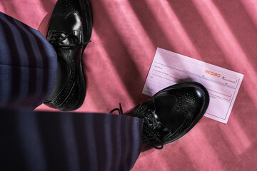 Business man stepping on receipt