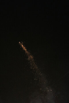 fireworks exploding in the air against a black sky 