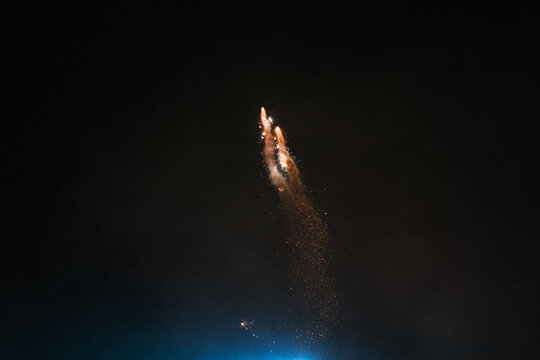 fireworks exploding in the air against a black sky 