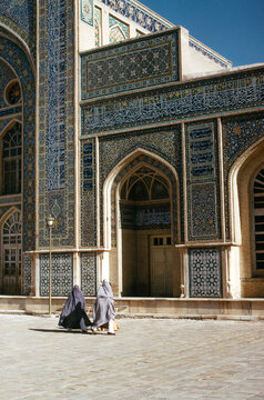 Three Veiled Women Walking In Front Of Mosque