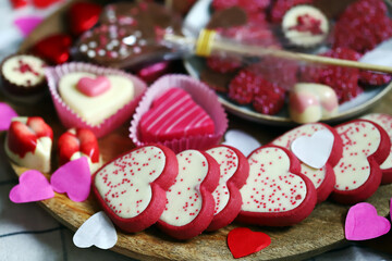 Sweets for Valentine's Day. Chocolates and cookies in the form of hearts.