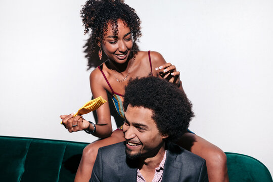 Black couple styling afro hair and smiling together