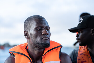 man in tourist boat with life jacket relaxing