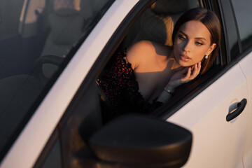 Fototapeta na wymiar portrait of a very attractive caucasian driver woman driving a car