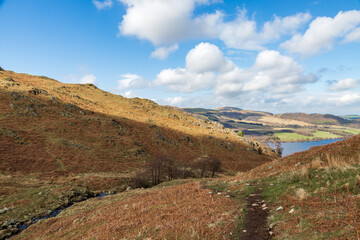 Fototapeta na wymiar A footpath leading towards Ullswater in Cumbria, on a sunny spring day