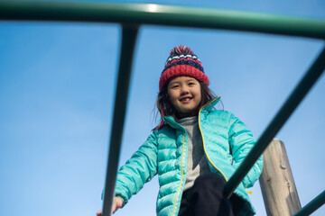 Happy kid climbing at the playground
