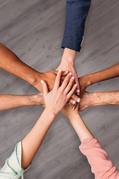 Multiracial Coworkers Stacking Hands