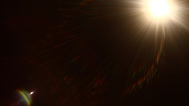 Easy to add lens flare effects for overlay designs or screen blending mode to make high-quality images. Abstract sun burst, digital flare, iridescent glare over black background.