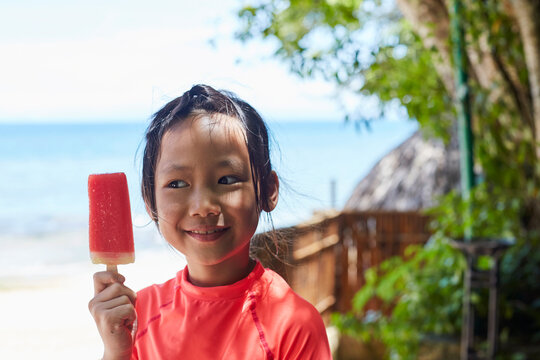 Asian Girl Happily Eating Her Favorite Watermelon Popsicle