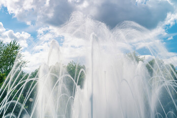Fountain water jets and splashes on a summer day.