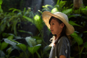 Asian girl in southeast asian yard with morning sunlight