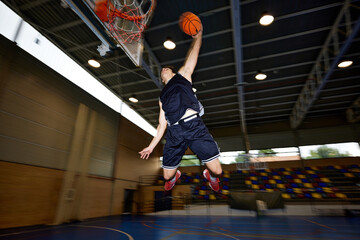 Basketball player throwing ball into hoop
