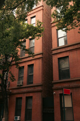 Fototapeta na wymiar Trees near brick buildings on brooklyn heights in New York City.