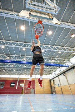 Basketball player throwing ball into hoop