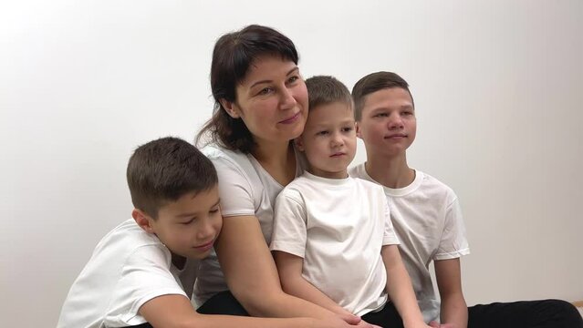 mother and three sons brothers children on white background school washing powder hygiene product cleanliness White t-shirts clothing store sitting looking like Ivan studio social services desire