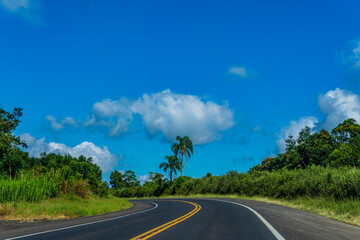 road curve and field with clouds