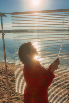 The girl regulates the amount of sunlight on her skin.