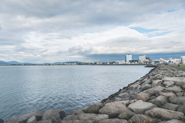 Fototapeta na wymiar Atlantic Ocean view in part of Reykjavik with buildings along the coast