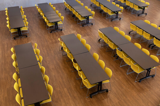 Yellow cafeteria Chairs with tables
