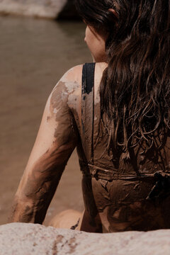 Girl enjoying mud-bathing